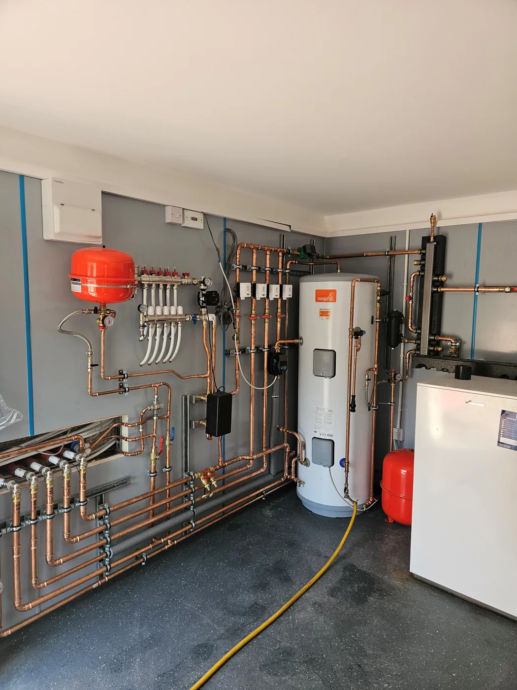 Plant room pipework and hot water cylinder installation