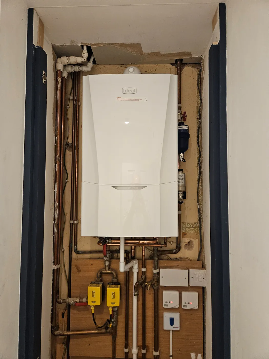 Boiler and pipework fitted into an alcove