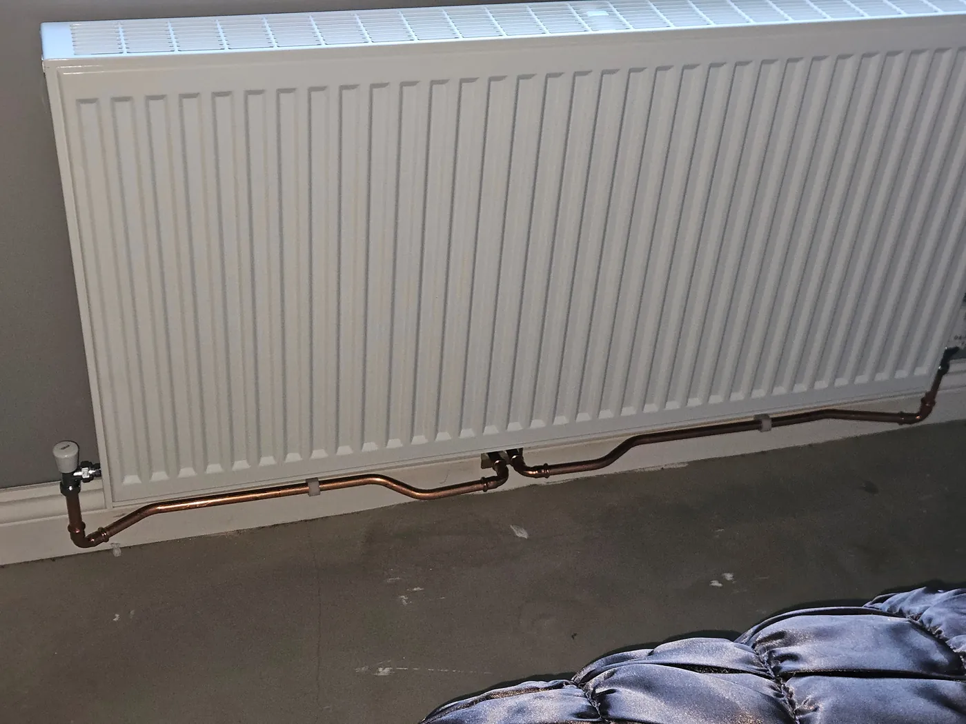 Radiator and neatly finished copper pipework